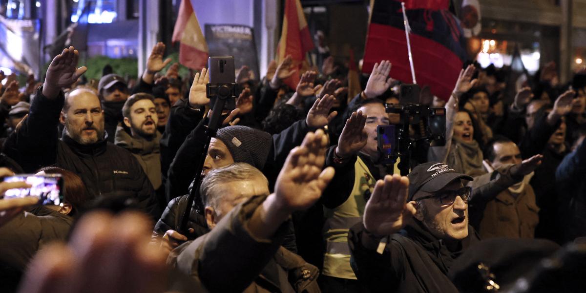 Fasiszta üdvözléssel köszöntik egymást a tüntetők. A megmozdulást a Falange Española de las JONS fasiszta párt szervezte november 21-én, Madridban. A spanyol diktátor, Francisco Franco halálának 50. évfordulójára emlékeztek