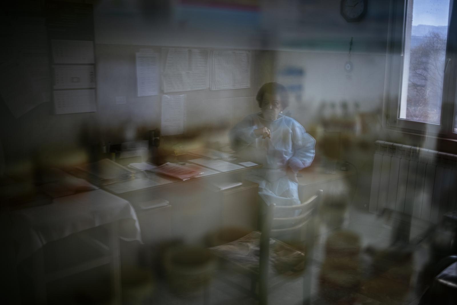 This picture taken on January 20, 2021 shows Bulgarian Infection disease specialist Dr Maria Bogoeva, 82, taking a short break during her shift in a Covid-19 unit in the hospital of Doupnitsa, a municipality with 50,000 inhabitants which is desperately la