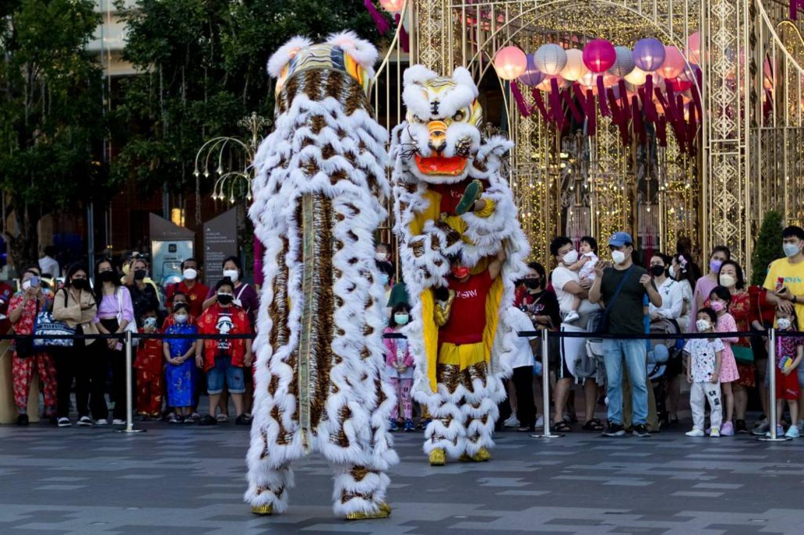 Egy férfi megtisztítja a tigris díszét, amely egy templom falát díszíti a közép-jávai Semarangban 2022. január 27-én, a holdújév előtt, amely február 1-jén vezeti be a tigris évét.