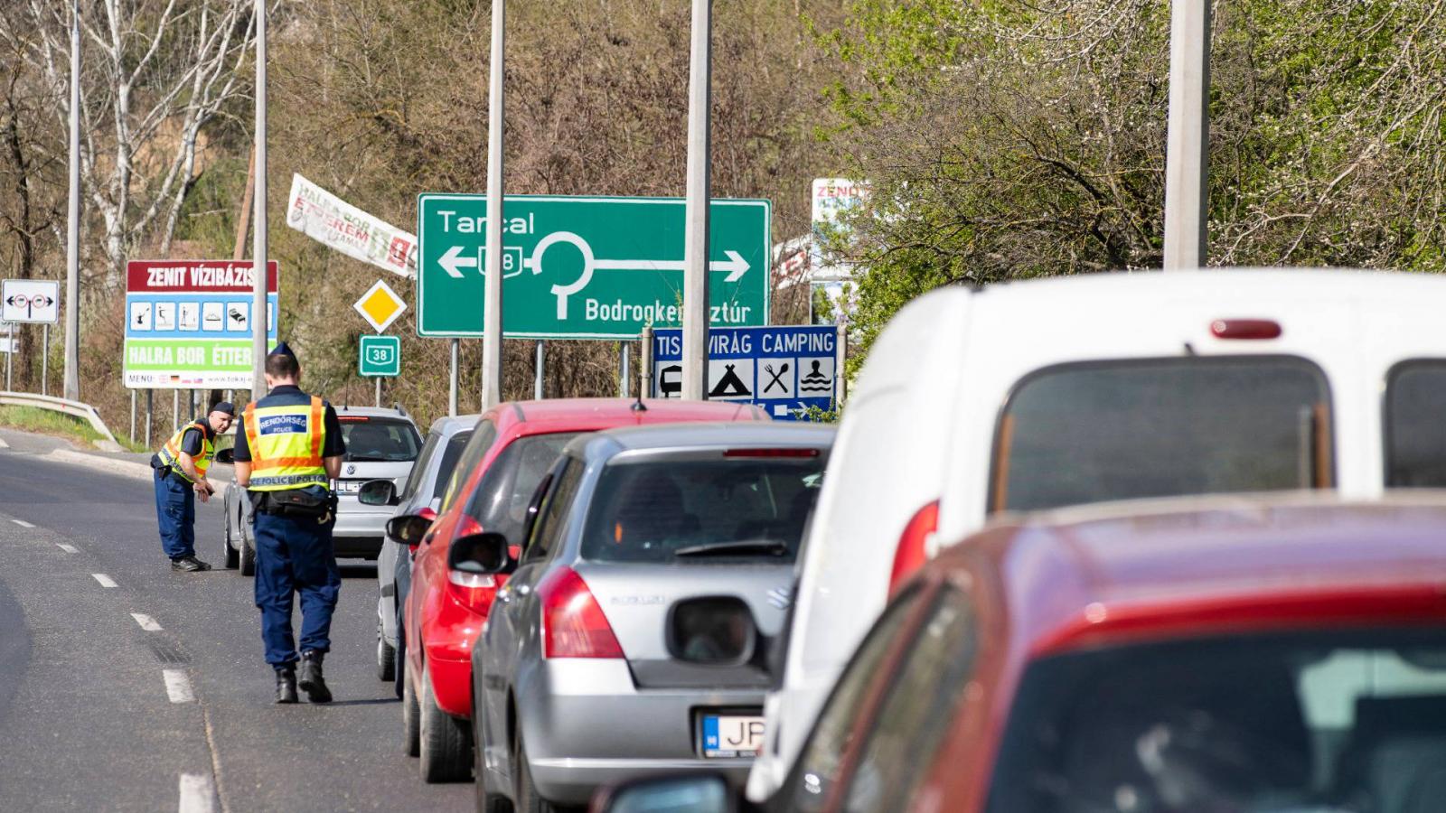 Rendőrök autósokat ellenőriznek a Tokaj és Rakamaz közötti Tisza-híd előtt 2020. április 10-én