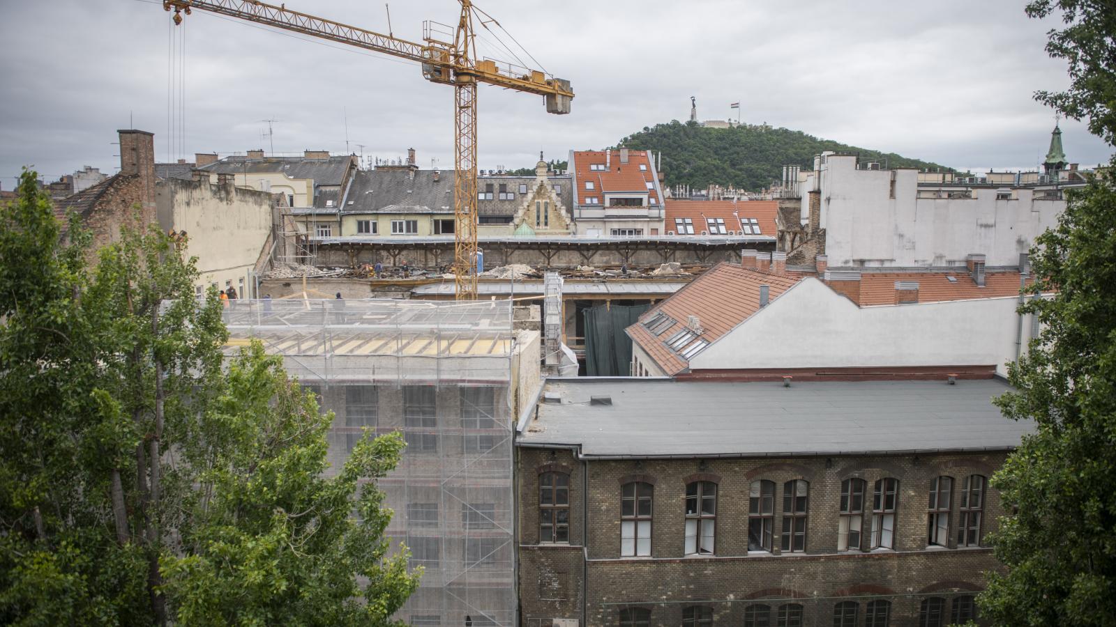 Az utcáról nem látszik, csak a szomszédos házak magasabb emeleti lakásaiból, hogy a belső udvaron daru forog. Az épület belső frontját elbontották