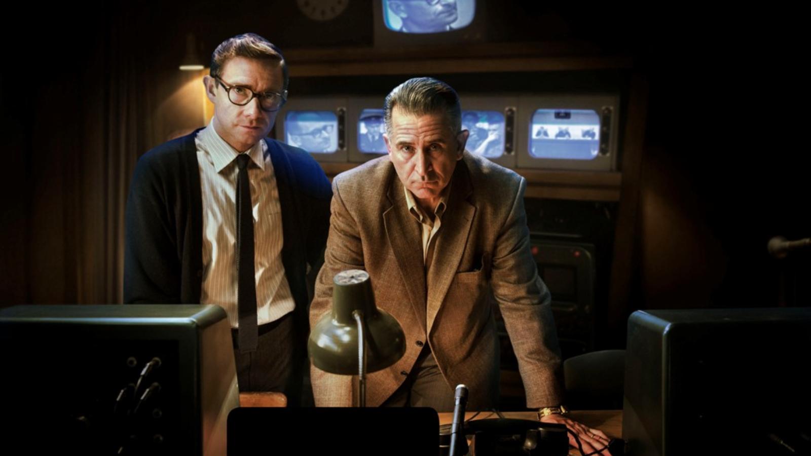 Martin Freeman és Anthony LaPaglia a producer és a rendező szerepében az ideiglenes jeruzsálemi tévéstúdióban, a monitorokon Eic