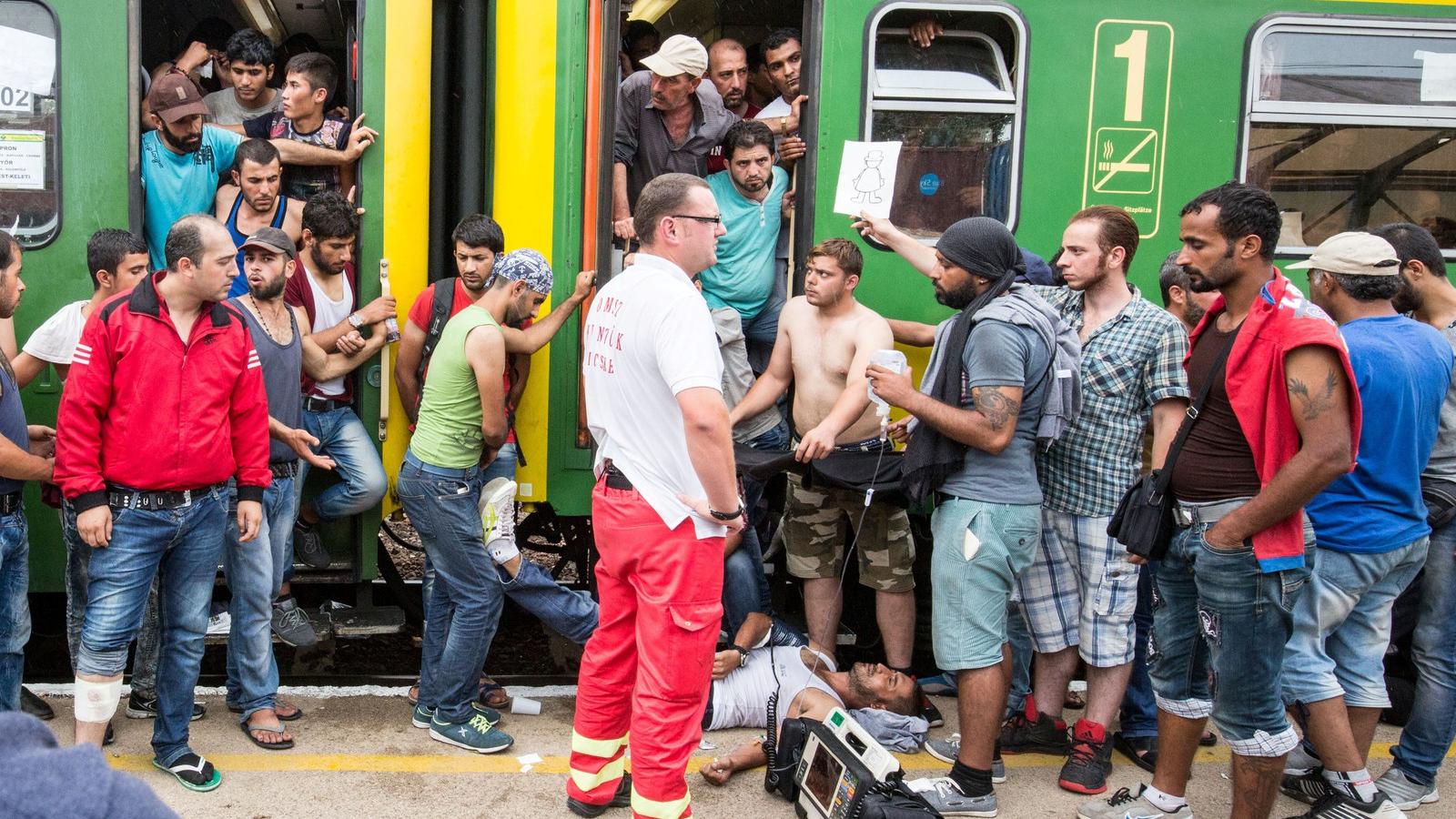 Budapest -2015 szeptember 3 - Egy menekültet ápolnak a mentők a pályaudvaron Fotó: Matt Cardy / Getty Images