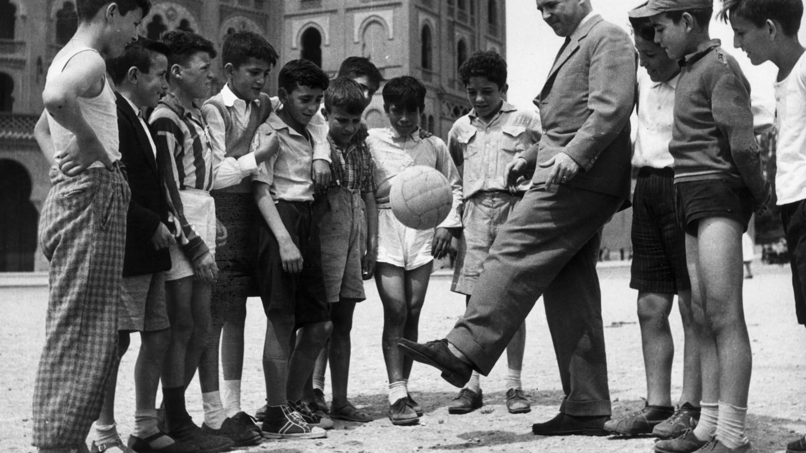 Puskás 1961-ben madridi gyerekeknek mutatja, hogyan kell ballal dekázni. Fotó: Keystone/Hulton Archive/Getty Images.